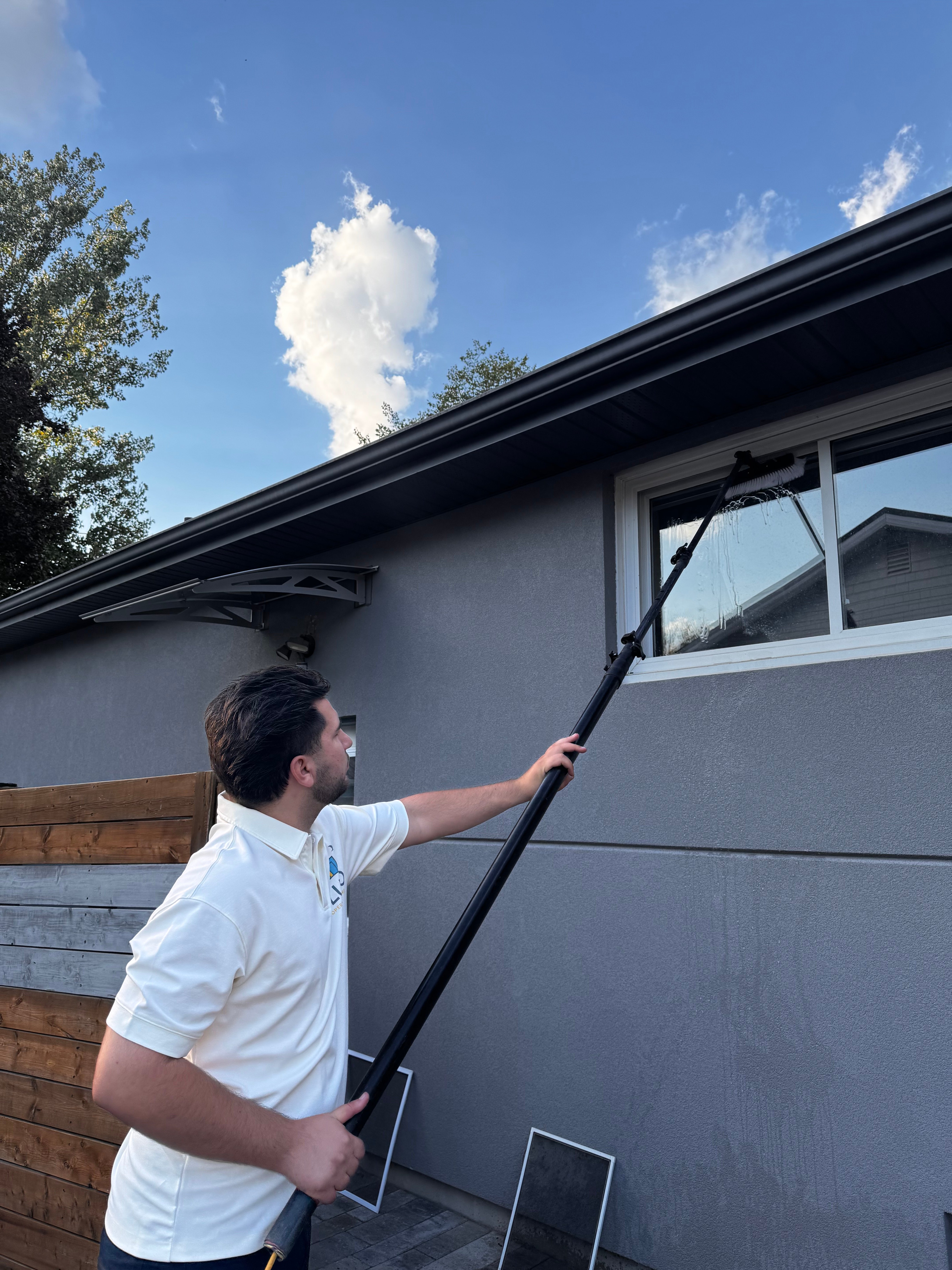 Pluto team member cleaning a window